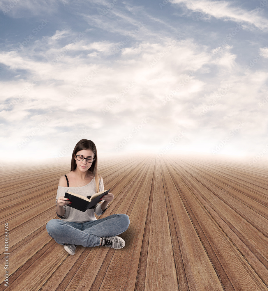 young woman reading sitting at abstract place