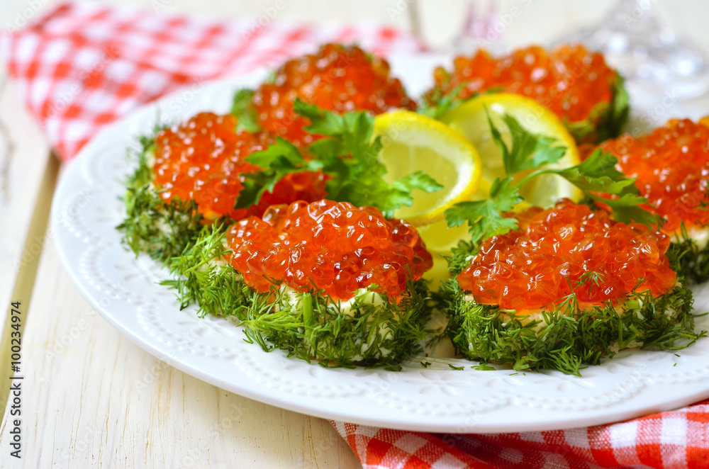 Delicious canapes with red caviar in the shape of a heart. Delicious canapes with red caviar in the shape of a heart.