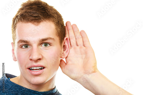 фотографія gossip boy with hand behind ear spying