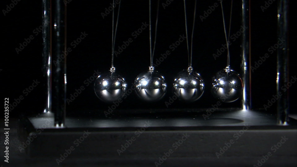 Newton's Cradle balls colliding on black background. Newton's Cradle balls colliding on black background.