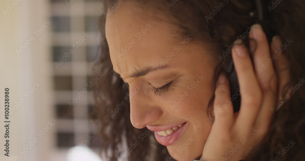 Closeup of a beautiful young latino woman wearing headphones Closeup of a beautiful young latino woman wearing headphones