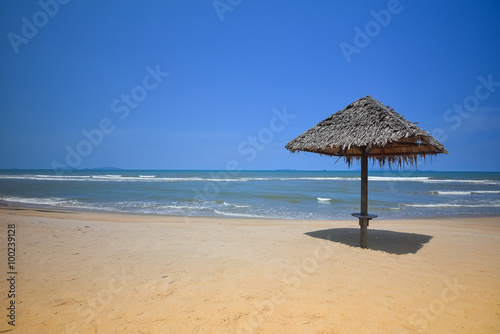 Vacation Concept. Attap dwelling umbrella on sand beach with blue sky at Terengganu Islands, Malaysia © zakies