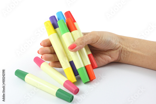 colored markers in hand on the white background