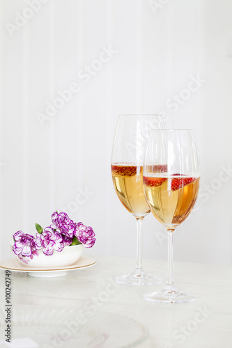 Glasses of sparkling wine on table
