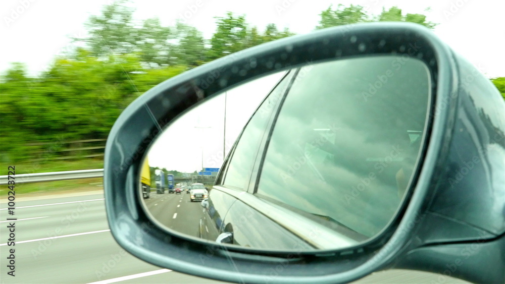 Highway view on side mirror of a car Highway view on side mirror of a car