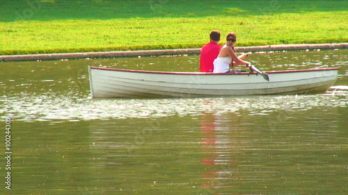 Young couple rowing a boat in a pond at Versailles, France. photo