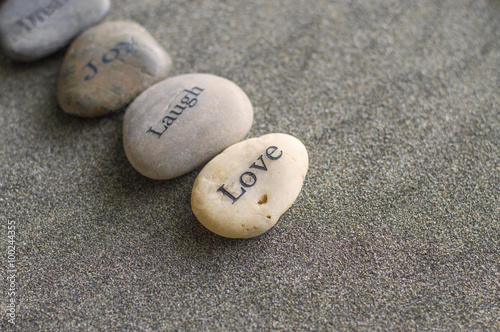 Pebbles printed with words love, dream, joy  photo