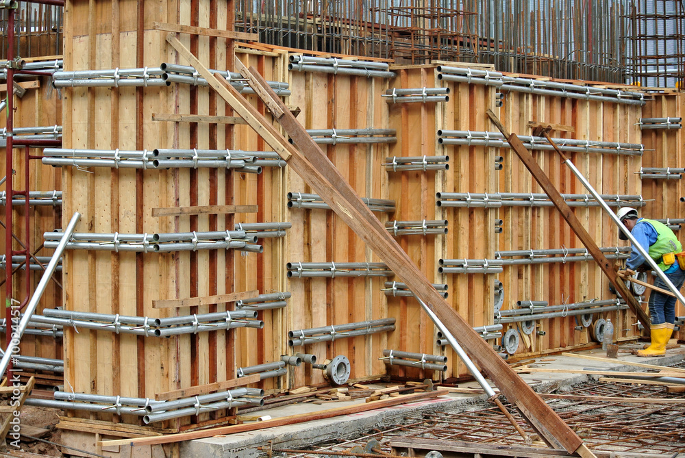 Construction workers fabricating reinforcement concrete wall form work