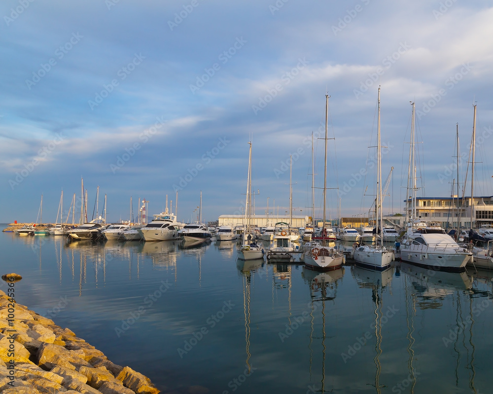 Yachts and sailboats moored in the marina near Valencia, Spain. Sailing is one of the most favorite recreational activities in Spain where almost every coastal town has a picturesque marina.