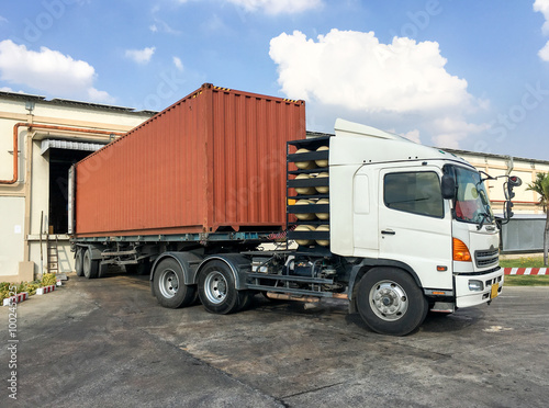 Container truck loading goods at warehouse