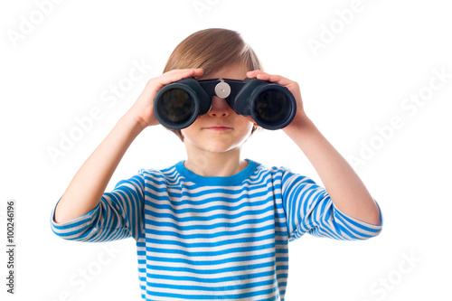 Little boy is looking through binocular, isolated on white background