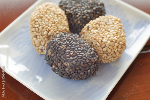Gomadango is the traditional sweets of Japan. It covers the containing rice cake with red bean paste with white sesame and black sesame.   © caycebilly