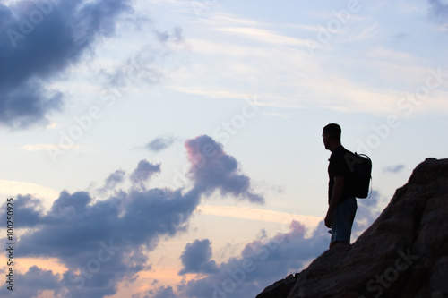 the man costs on stones and looking in a distance