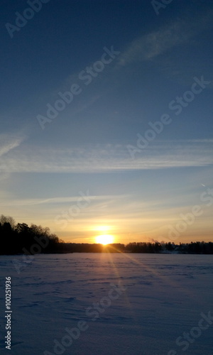 Winter sunset on the frozen lake in Russia