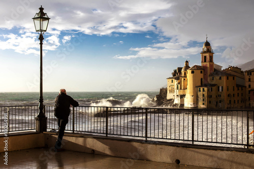 SENIOR MAN WATCHING cAMOGLI WITH ROUGH SEA