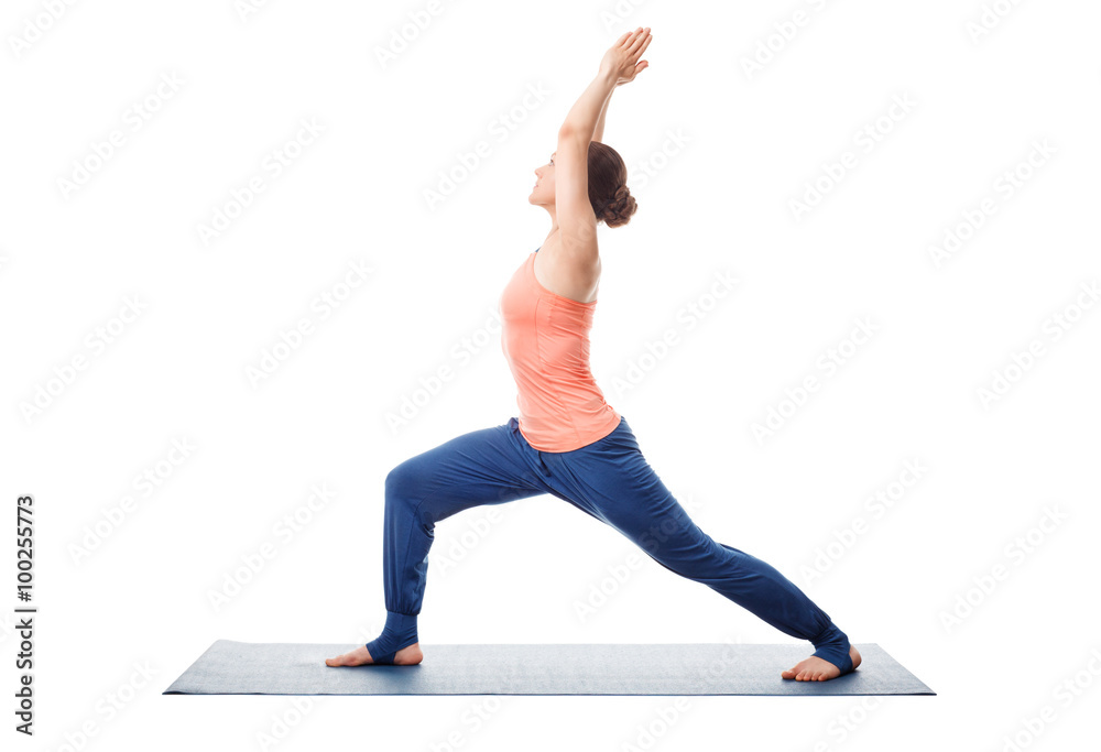 Sporty fit yogini woman practices yoga asana utthita Virabhadras