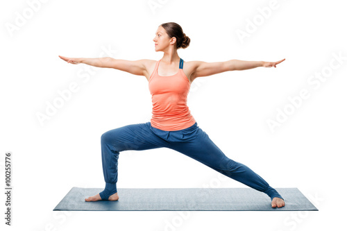 Sporty fit yogini woman practices yoga asana utthita Virabhadras