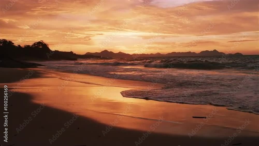Slow motion tracking shot of huge waves crashing on Devil's beach (Praia do Diabo) at sunset