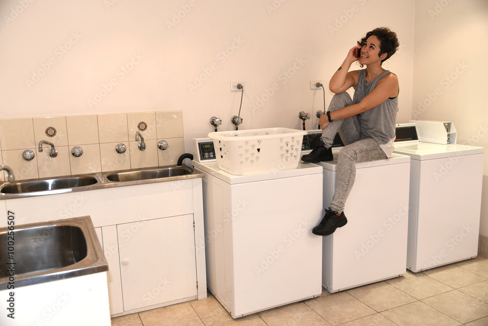 young girl waiting for the washing machine young girl waiting for the washing machine