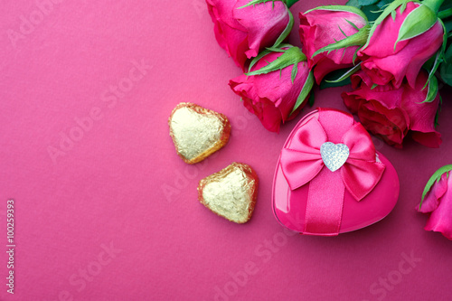 Pink roses and gift with copyspace.