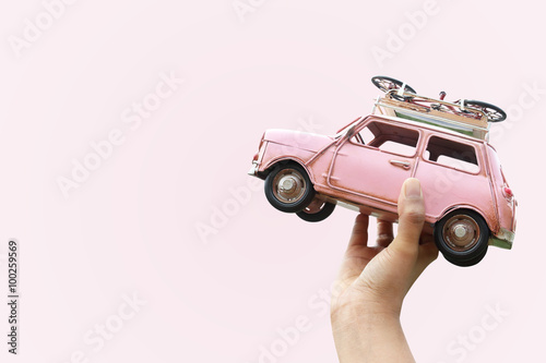 Hand holding classic mini model with bicycle, Travel concept photo