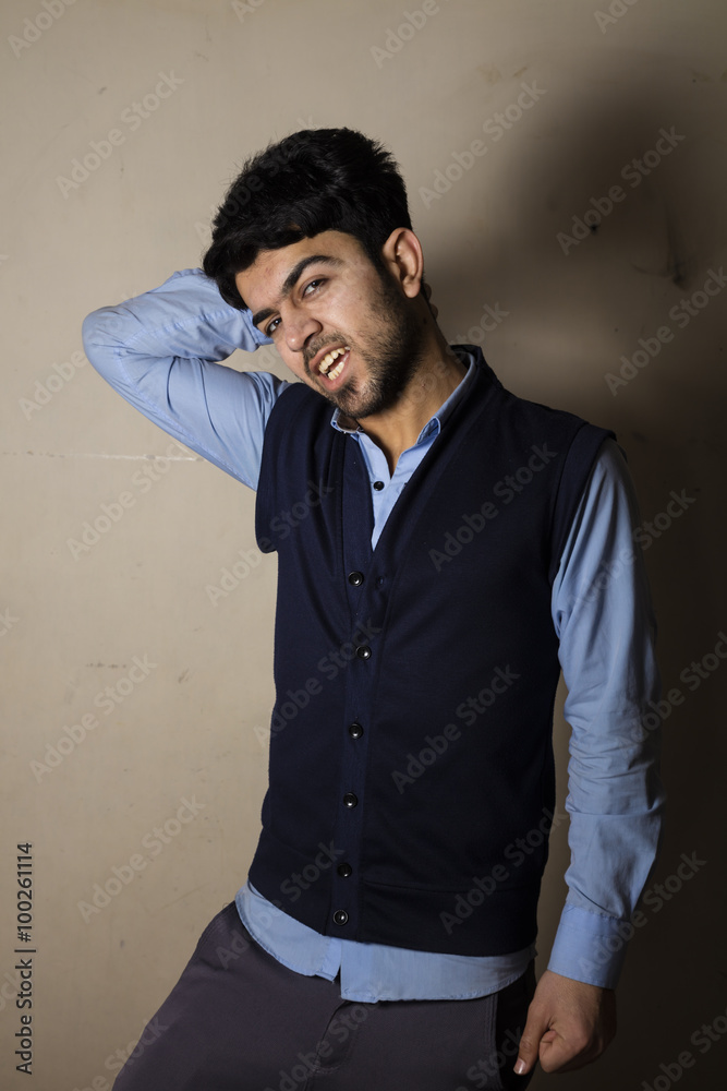 Iraqi brunette boy in strange pose inside studio
