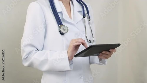 Wallpaper Mural The doctor in a white coat working with the tablet. Torontodigital.ca