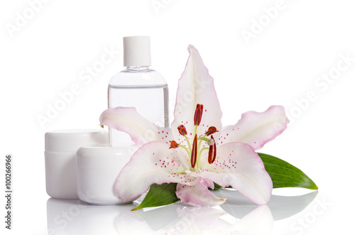 cosmetic set for skin care on a white background with lily flowe