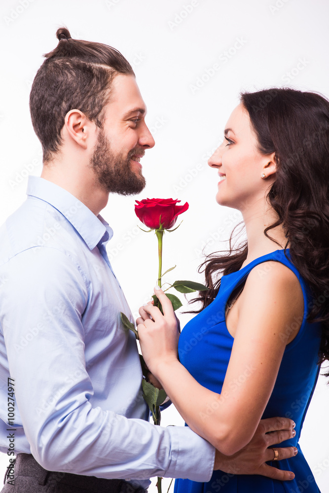 Smiling caucasian woman hugging her boyfriend and holding the rose. Smiling caucasian woman hugging her boyfriend and holding the rose.