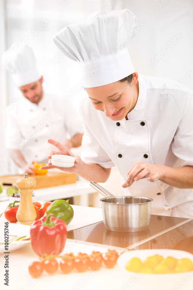 Young attractive professional chef cooking in his kitchen Young attractive professional chef cooking in his kitchen