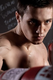 Handsome young boxing champion is training hard