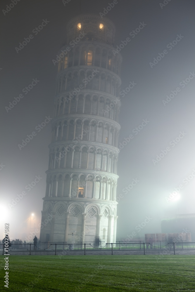 Leaning tower of Pisa in dense fog by night.
