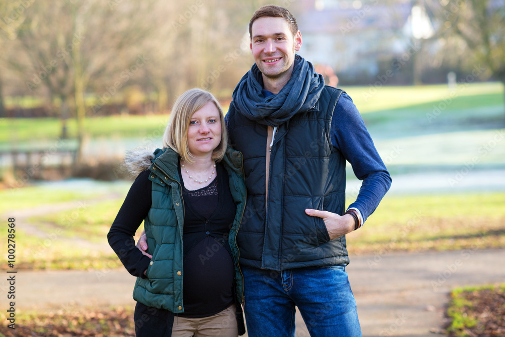 pregnant woman with her husband in the park