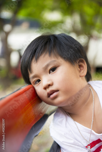 Boy sit and relax on the chair.