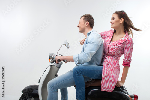 Attractive young man and woman on motorbike