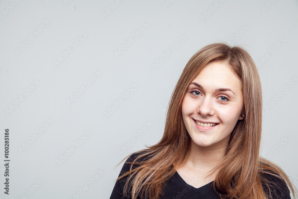 Fototapeta premium Attractive woman with black t-shirt isolated on a over white background