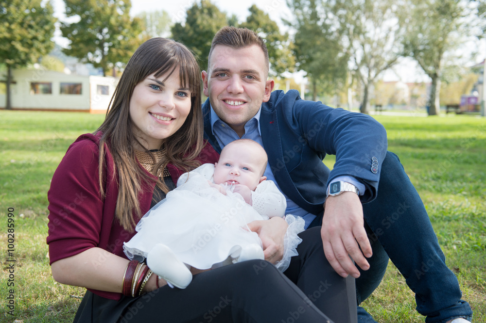 Young family with first baby in the park Young family with first baby in the park