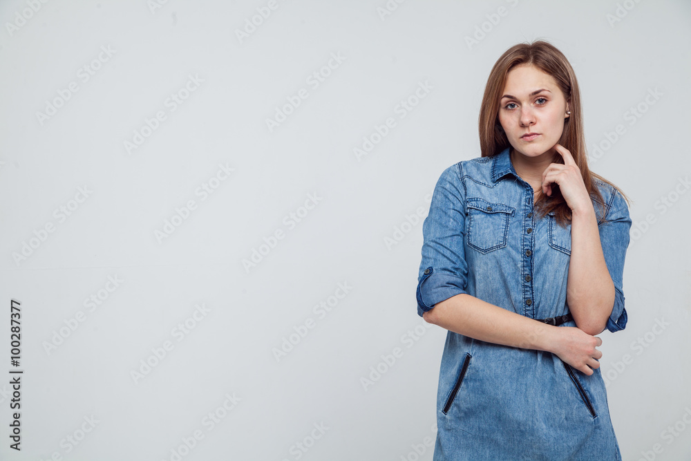 Portrait of a girl in a blue denim dress - isolated on white background Portrait of a girl in a blue denim dress - isolated on white background