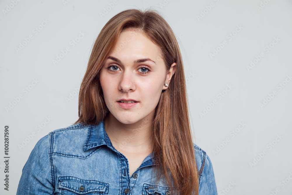 Portrait of a girl in a blue denim dress - isolated on white background Portrait of a girl in a blue denim dress - isolated on white background