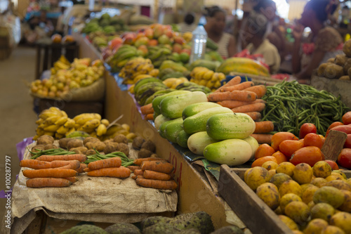 Obraz na plátně Many different vegetables on shelfs on an Asian market