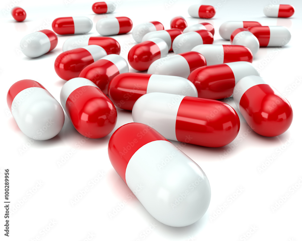 scattered red and white pills on white background scattered red and white pills on white background
