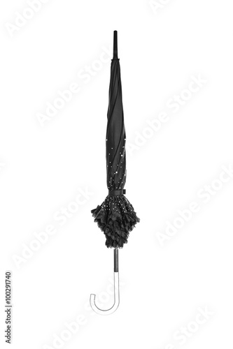 Closed black umbrella decorated with crystals on white