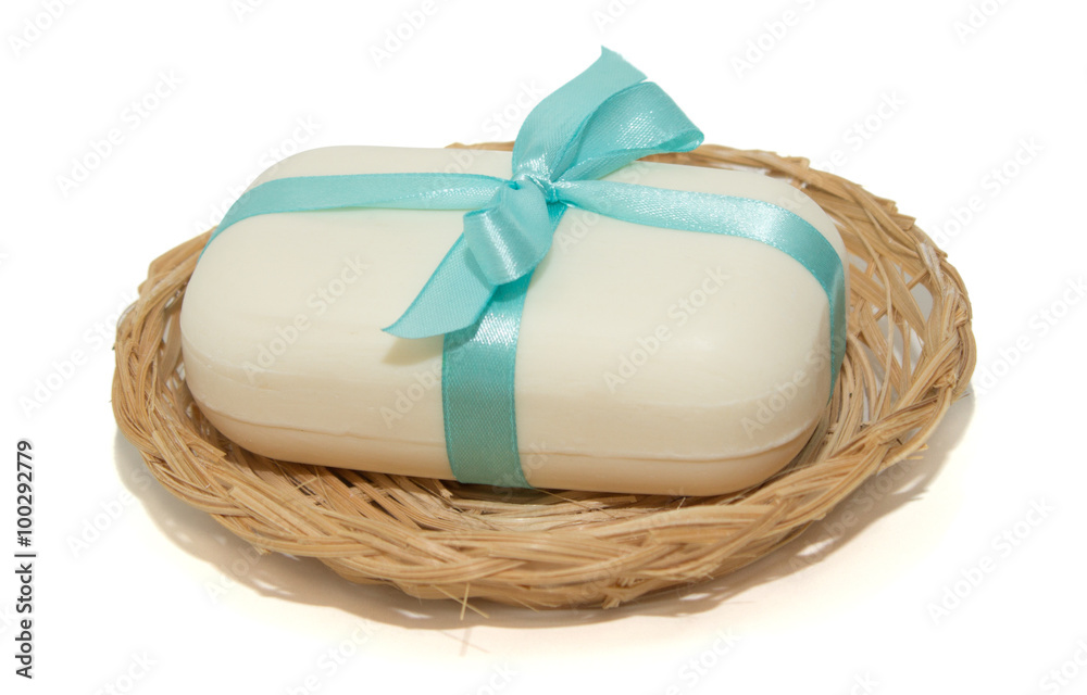 isolation photo of soap with a bow in a basket on a white backgr