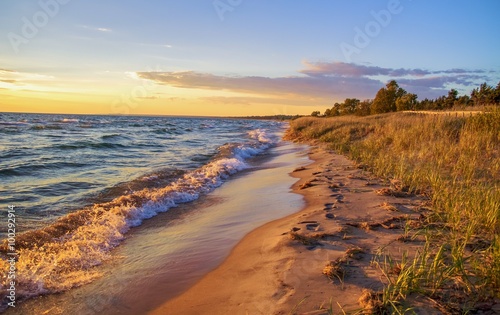 Beach Background. Beautiful sandy beach stretches to the blue sky horizon.