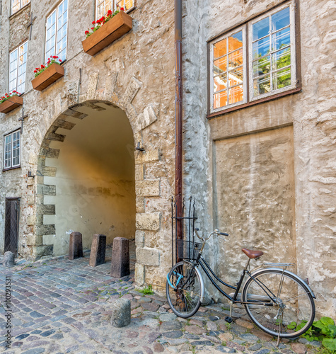 Medieval street in old Riga. Riga is the capital and largest city of Latvia, a major commercial, cultural, historical and tourist center of the Baltic region