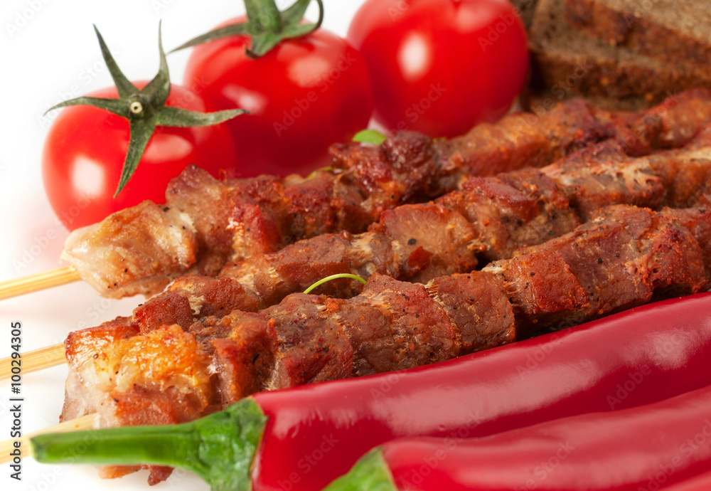 Shish kebab on bamboo sticks with cherry tomatoes Shish kebab on bamboo sticks with cherry tomatoes