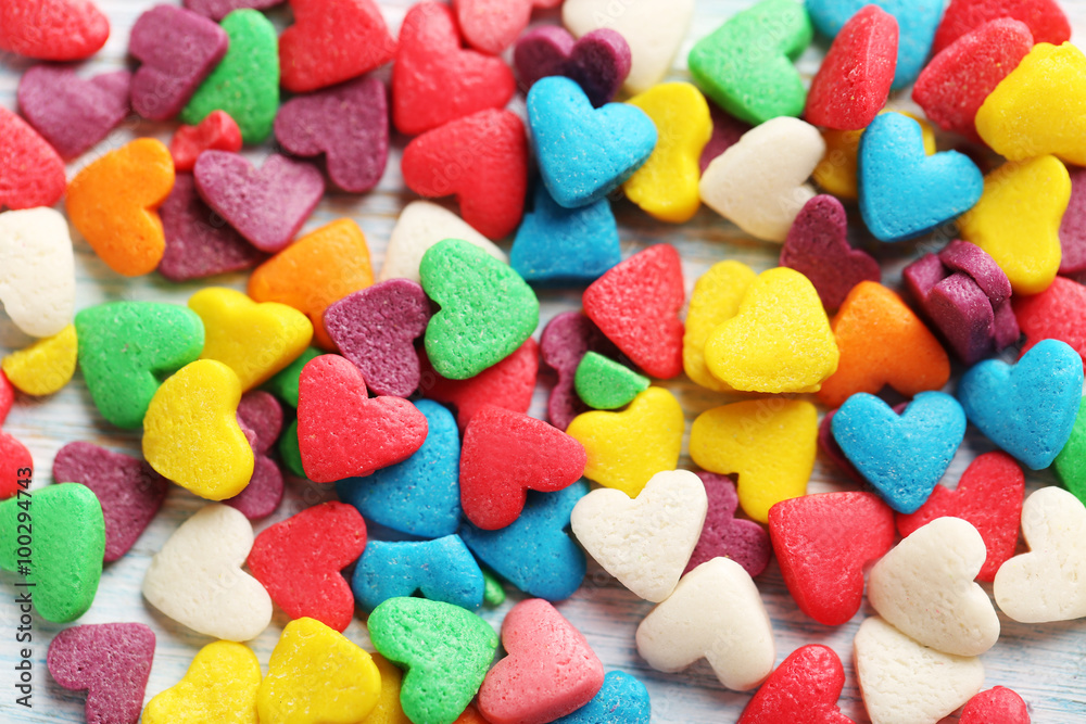 Colorful candy hearts on a blue wooden table - obrazy, fototapety, plakaty 
