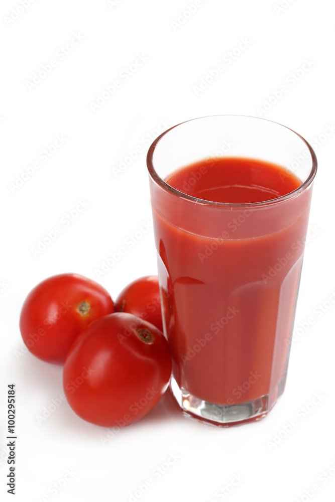 Fresh red tomatoes and tomato juice in glass isolated on white Fresh red tomatoes and tomato juice in glass isolated on white