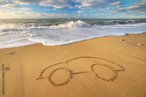Fototapeta Naklejka Na Ścianę i Meble -  Draw car on beach sand.