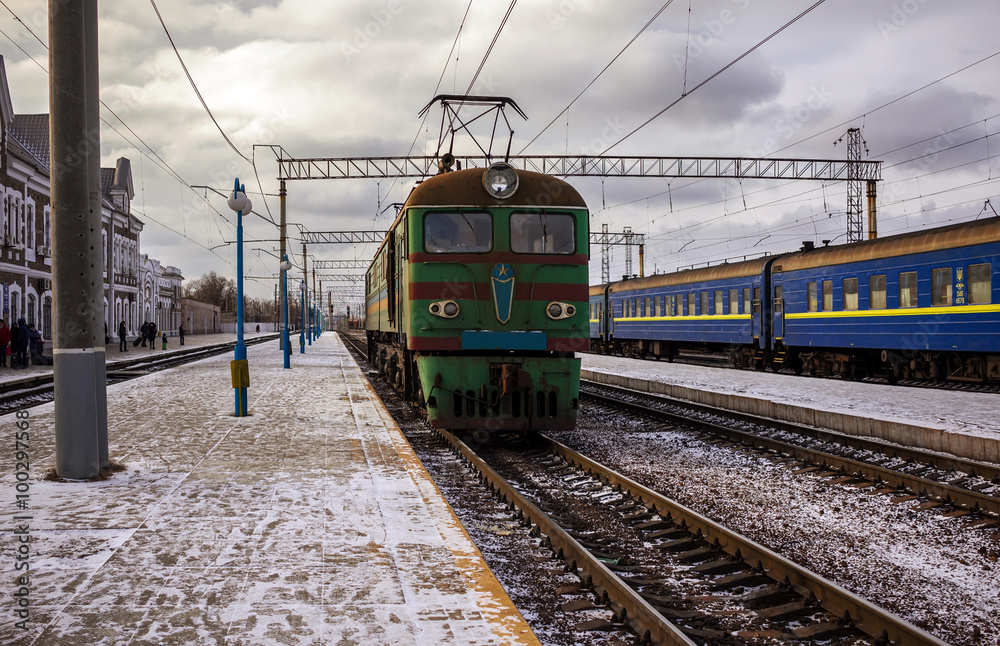 train departs from the platform against the sky with clouds
